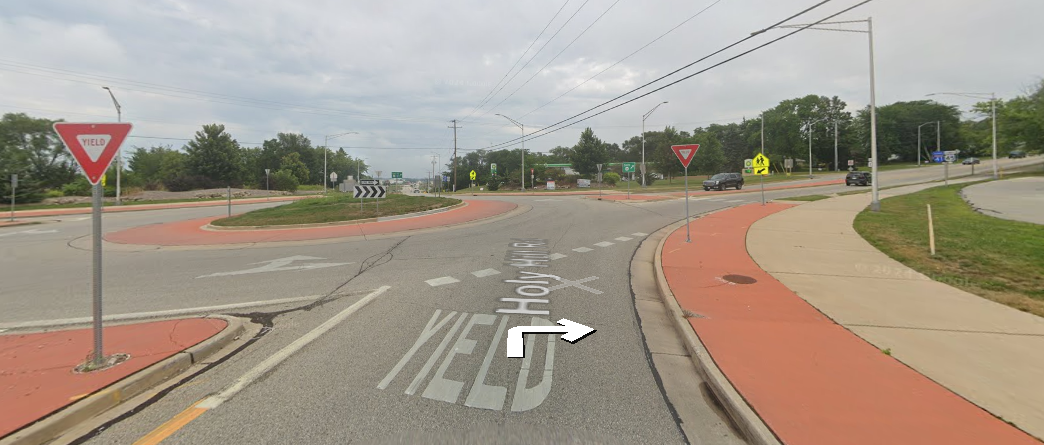 At the traffic circle, continue straight onto WI-167 E/Holy Hill Rd